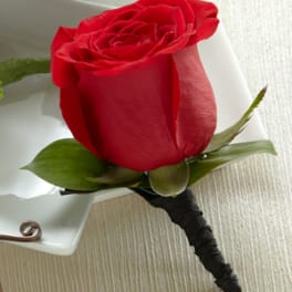 Single red rose boutonniere with white wrap