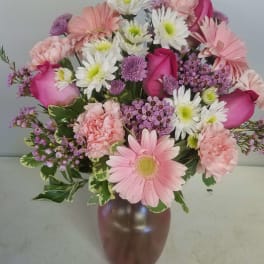 Pink and white mixed bouquet in a brown vase