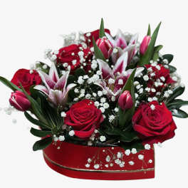 Heart-shaped box of red roses and pink lilies with baby's breath
