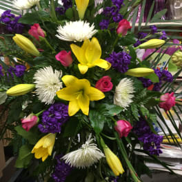 Bouquet with yellow lilies, white spider mums, pink roses, and purple flowers