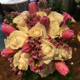 Bouquet of white roses and pink tulips with small pink filler flowers
