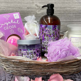 Spa gift basket with lavender bath products and a crystal geode bath bomb