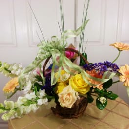Basket arrangement with yellow roses, peach daisies, and white snapdragons
