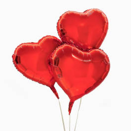 Three red heart-shaped balloons on sticks