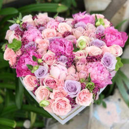 Heart-shaped bouquet of pink and lavender roses with peonies