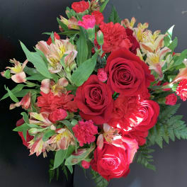 Bouquet of red roses, carnations, and striped alstroemeria