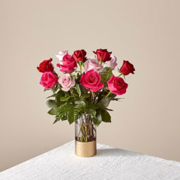 Bouquet of pink and red roses in a clear glass vase