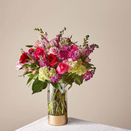 Pink and red rose bouquet in a clear glass vase