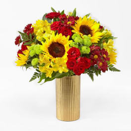 Bouquet of sunflowers, red roses, and yellow alstroemeria in a gold vase
