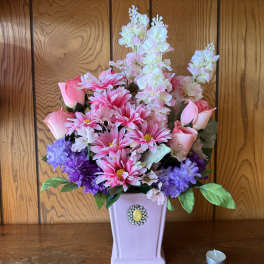 Pink and purple floral arrangement in a lavender vase