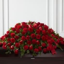 Large mound of red roses on a dark surface