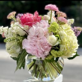 Pink and white floral arrangement in a clear glass vase