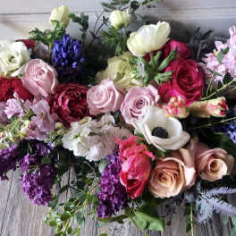 Mixed bouquet of roses, anemones, and hyacinths in pink, white, purple, and red