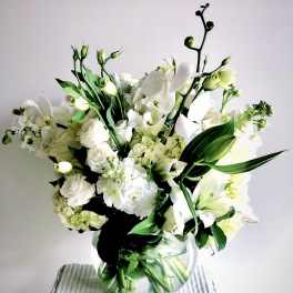 White floral bouquet in a clear glass vase
