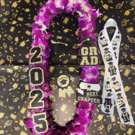 Purple orchid graduation lei with 2025 and grad charms on black background with gold caps.