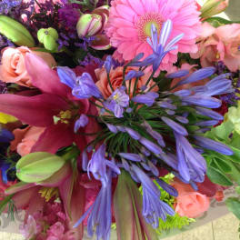 Colorful bouquet with pink lilies, roses, and purple flowers
