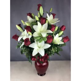 Red roses and white lilies in a burgundy vase