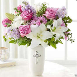 Pink roses and white lilies in a white vase