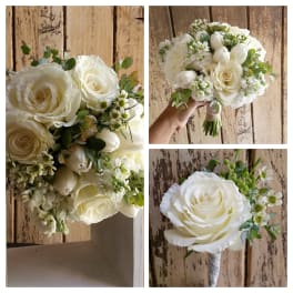 White rose bouquet with small white filler flowers and greenery