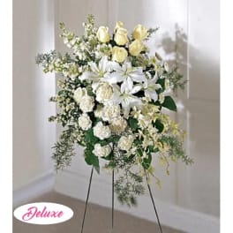 Standing floral spray with white lilies, yellow roses, and carnations