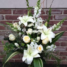 White lilies and cream roses in a tall arrangement