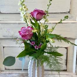 Pink roses and white flowers in a white vase