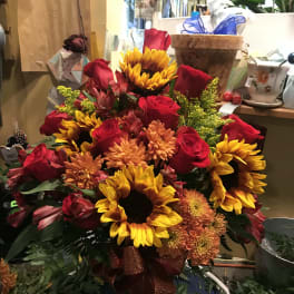Bouquet of red roses and sunflowers with orange mums