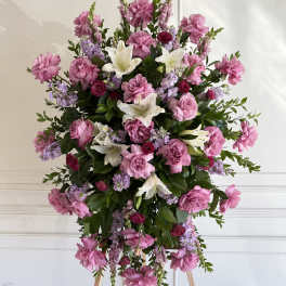Large pink and white floral standing spray on an easel
