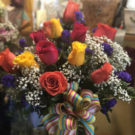 Bouquet of multicolored roses with baby's breath and a striped ribbon bow