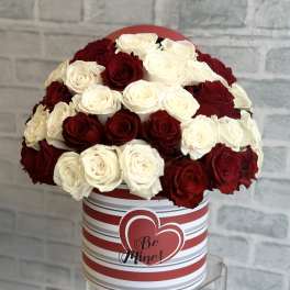 Red and white roses in a striped heart box with "Be Mine" text