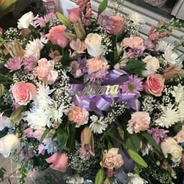 Large floral spray with pink and white roses, daisies, and carnations