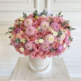 Large pink rose and dahlia arrangement in a white hatbox
