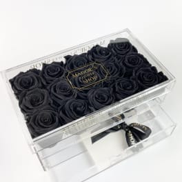 Black roses in a clear acrylic gift box with a drawer and ribbon