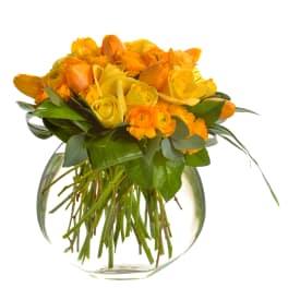 Yellow and orange rose bouquet in a clear glass vase
