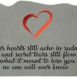 Gray memorial plaque with a red heart and sympathy quote