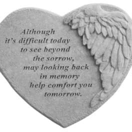 Heart-shaped memorial stone with engraved text and angel wings