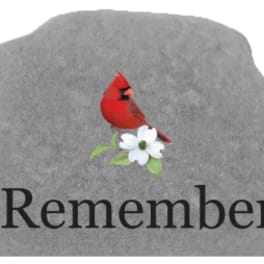Gray memorial stone with a red cardinal and white flower above the word Remember