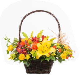 Basket arrangement with yellow lilies, roses, and red flowers