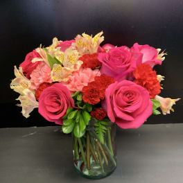 Pink roses and carnations in a glass vase