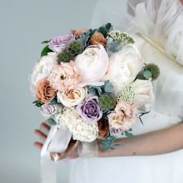 Pastel bridal bouquet with roses, peonies, and carnations