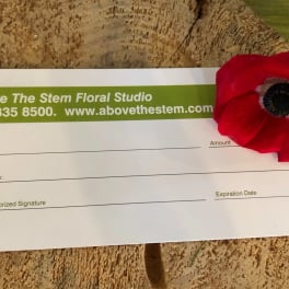 Gift card with a red flower attached