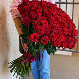 Large bouquet of red roses held by a person