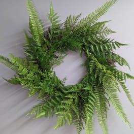 Green fern wreath on a light background