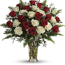 Bouquet of red and white roses in a clear glass vase