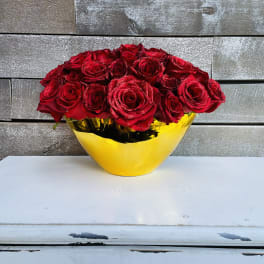 Red roses arranged in a yellow vase