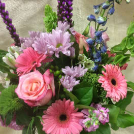 Mixed bouquet with pink gerbera daisies, lavender daisies, and a pink rose
