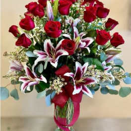 Bouquet of red roses and white lilies in a glass vase