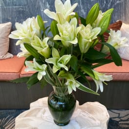 White lilies arranged in a glass vase