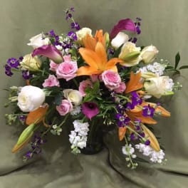 Mixed bouquet with orange lilies, pink roses, white roses, and purple calla lilies