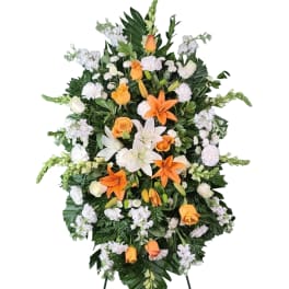 Standing floral spray with orange and white flowers on a white background
